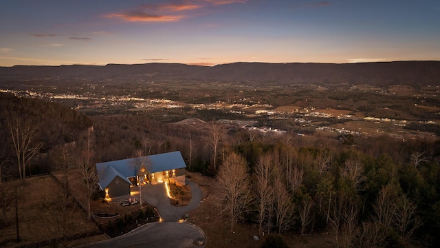 aerial view at dusk featuring a mountain view