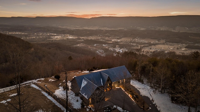 aerial view at dusk featuring a mountain view