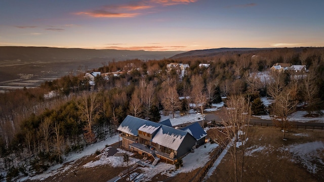 snowy aerial view with a mountain view