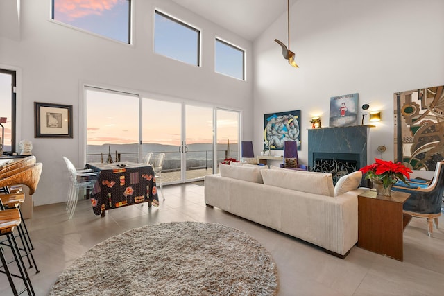 living room featuring a high ceiling and a high end fireplace