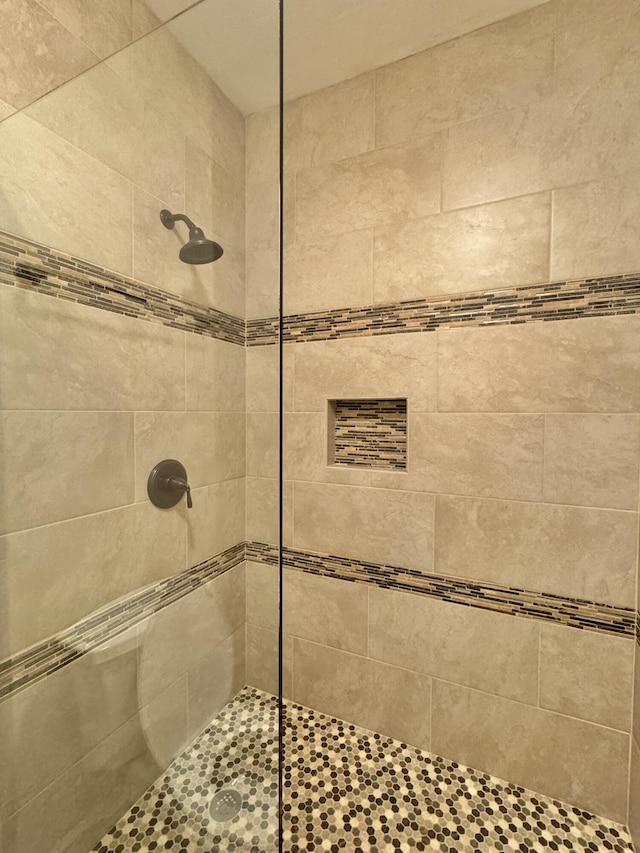 bathroom with a tile shower