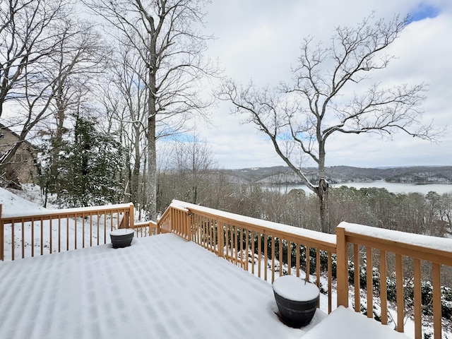 snow covered deck with a water view