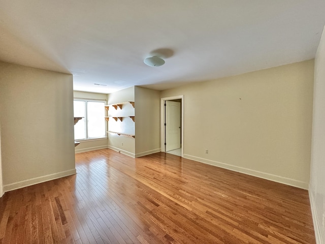 unfurnished room featuring hardwood / wood-style flooring