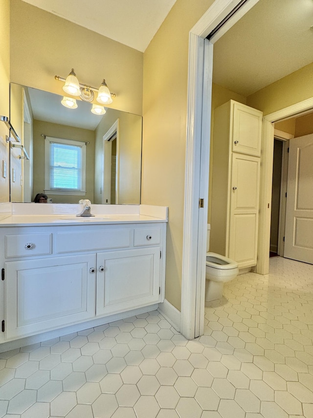 bathroom with tile patterned floors, vanity, and toilet