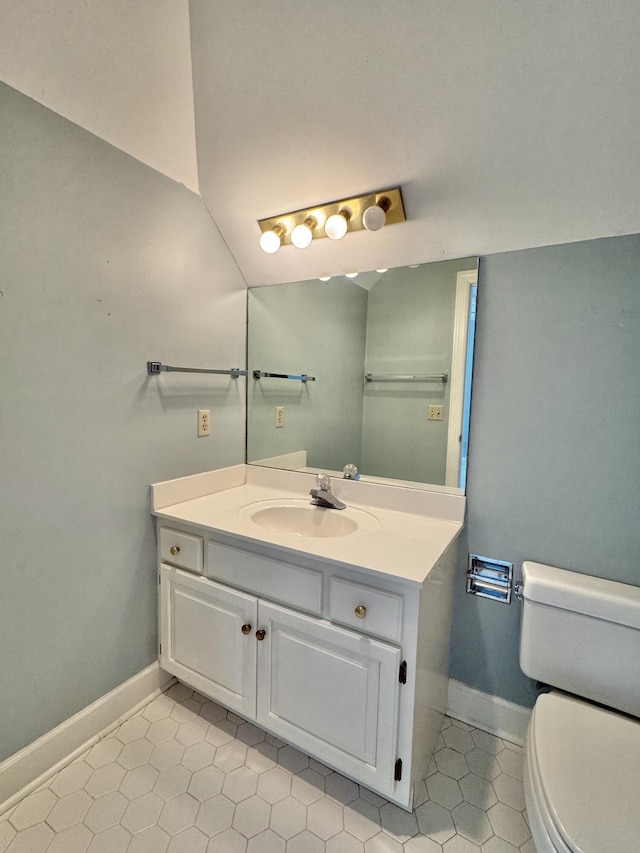 bathroom with tile patterned floors, vanity, and toilet