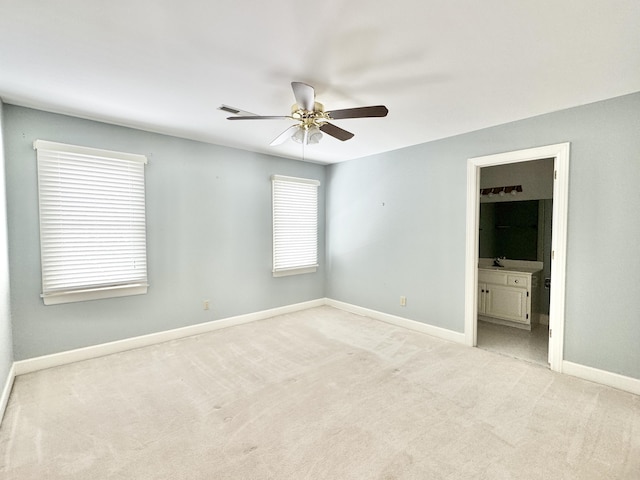 carpeted spare room with ceiling fan and sink