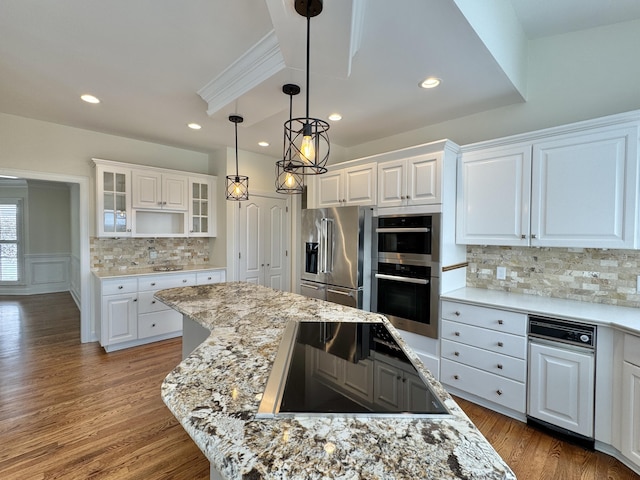 kitchen with white cabinetry, light stone counters, and appliances with stainless steel finishes