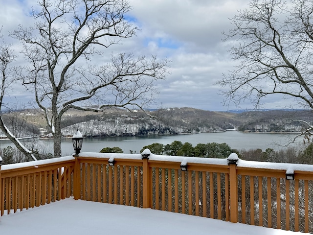 snow covered deck with a water view