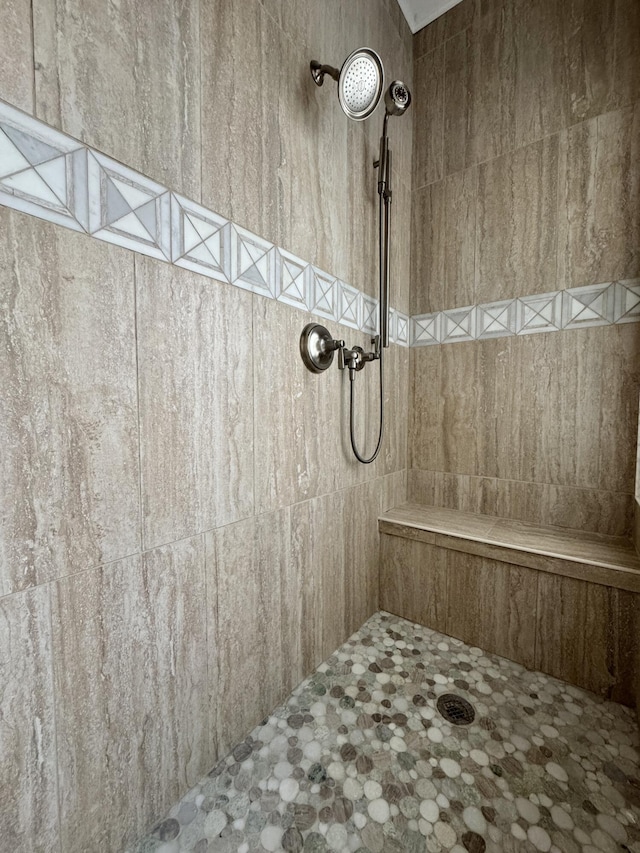 bathroom with a tile shower