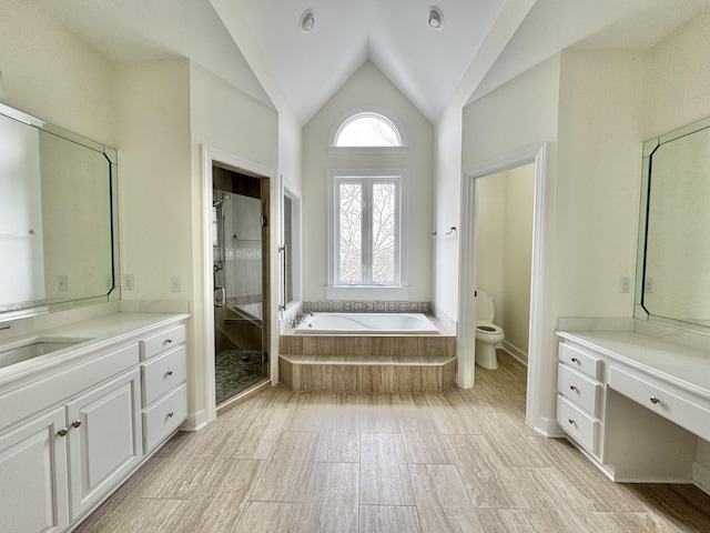 full bathroom with vanity, plus walk in shower, lofted ceiling, and toilet