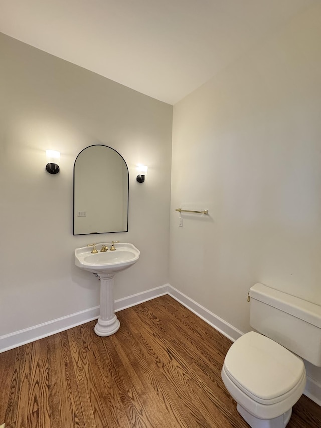 bathroom featuring toilet and hardwood / wood-style flooring