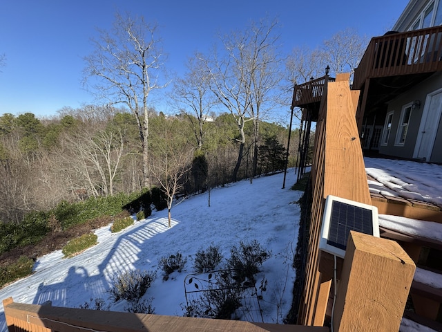 snowy yard featuring a balcony