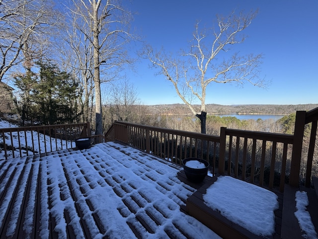 snow covered deck with a water view