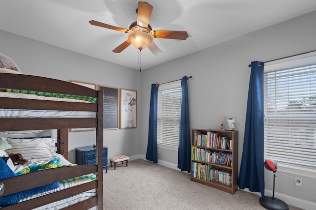 bedroom featuring ceiling fan and carpet