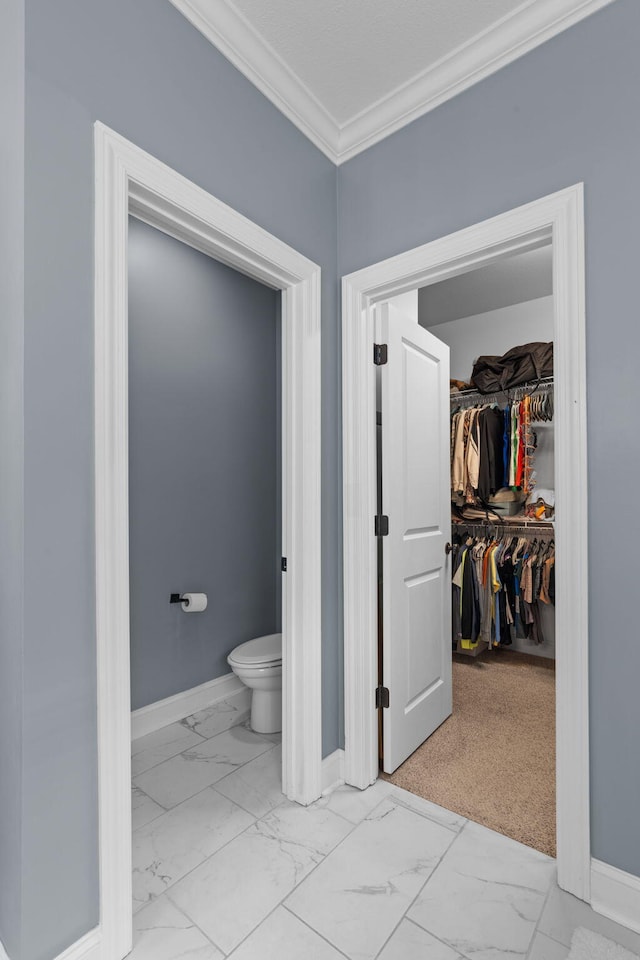 bathroom featuring toilet and ornamental molding