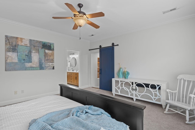 bedroom featuring carpet, ensuite bath, ornamental molding, ceiling fan, and a barn door