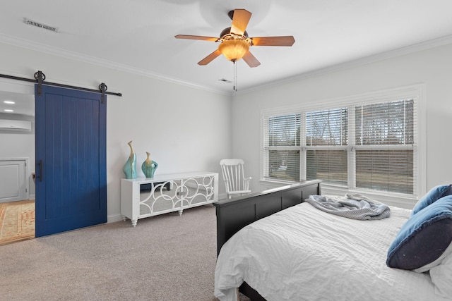 bedroom featuring a wall mounted AC, a barn door, ceiling fan, carpet floors, and crown molding