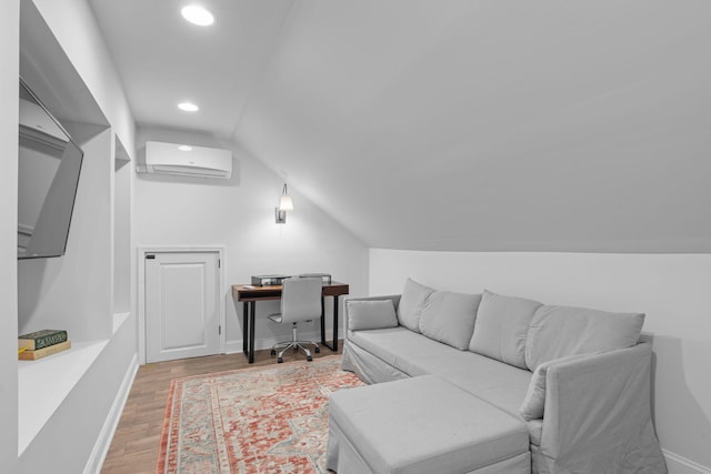 interior space with lofted ceiling, wood-type flooring, and a wall mounted air conditioner