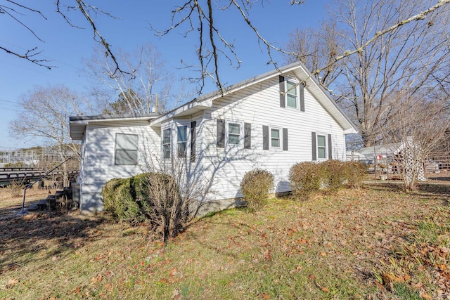 view of property exterior featuring a lawn