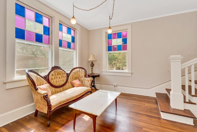 sitting room featuring crown molding, dark wood-type flooring, and ornate columns