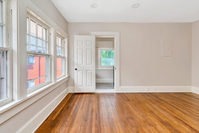 unfurnished room with dark wood-type flooring