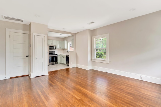 unfurnished living room featuring light hardwood / wood-style flooring