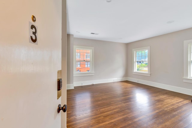 empty room featuring dark hardwood / wood-style flooring