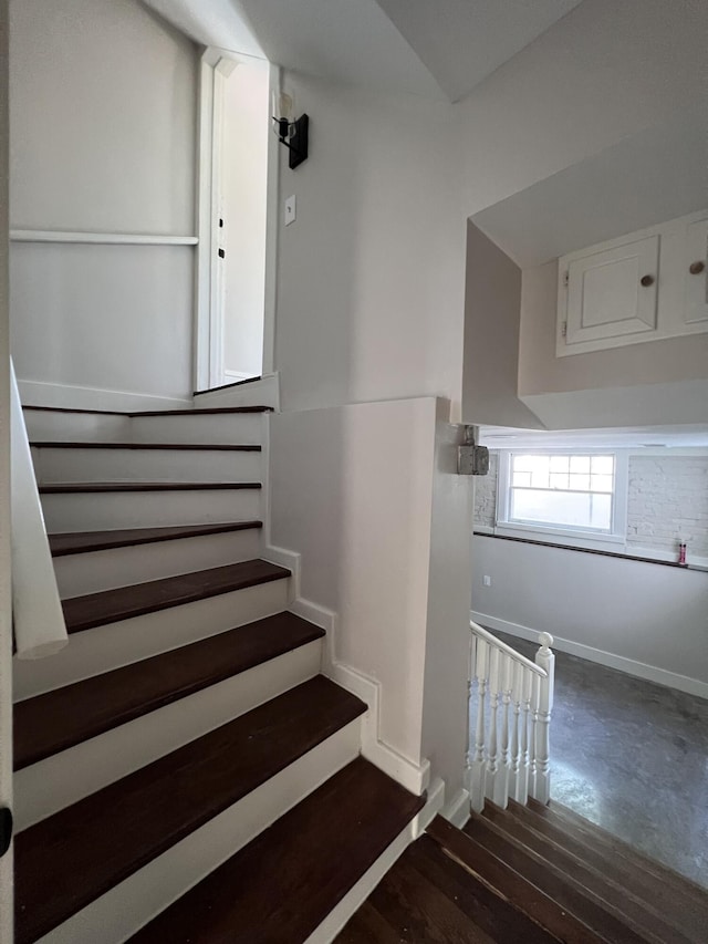 stairs featuring hardwood / wood-style floors