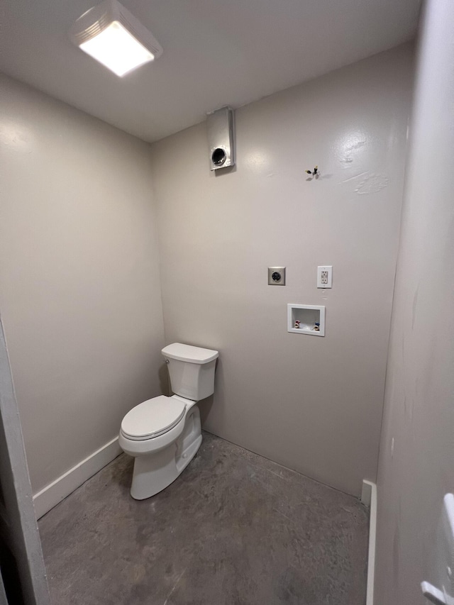 bathroom featuring concrete flooring and toilet