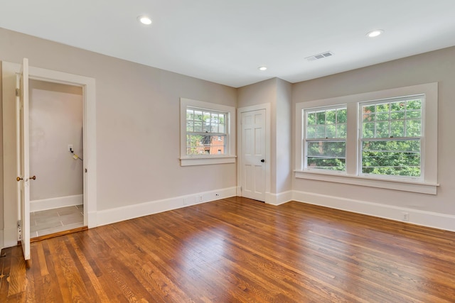 unfurnished room with hardwood / wood-style flooring