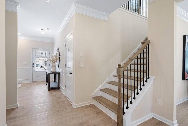 staircase featuring hardwood / wood-style flooring and ornamental molding