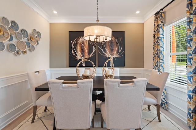 dining room featuring a wainscoted wall, light wood-style flooring, recessed lighting, an inviting chandelier, and crown molding