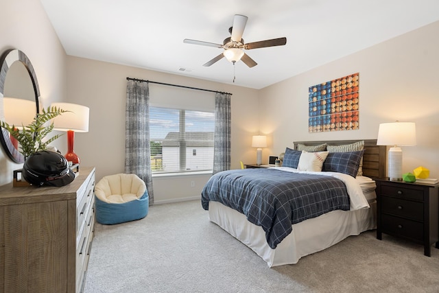 bedroom with ceiling fan and light carpet