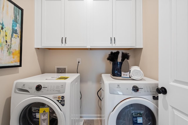 laundry room with cabinets and washer and dryer