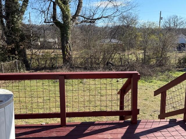 wooden terrace featuring a yard