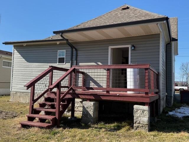 rear view of property featuring a wooden deck