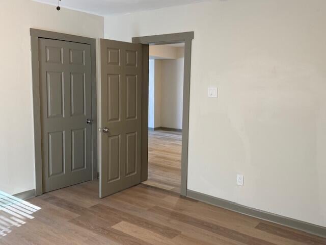 spare room with light hardwood / wood-style flooring