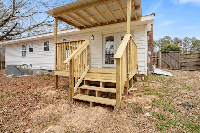 doorway to property with central AC and a wooden deck