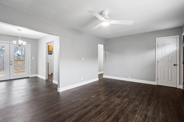 unfurnished room with ceiling fan with notable chandelier, french doors, and dark hardwood / wood-style flooring