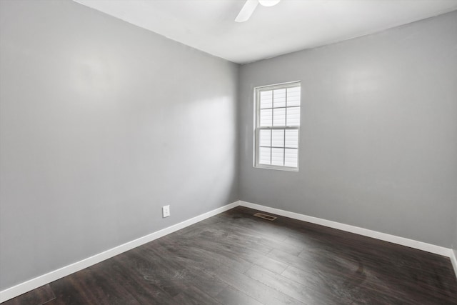 empty room featuring dark hardwood / wood-style floors and ceiling fan