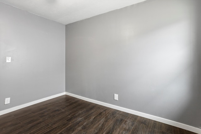 spare room with dark wood-type flooring