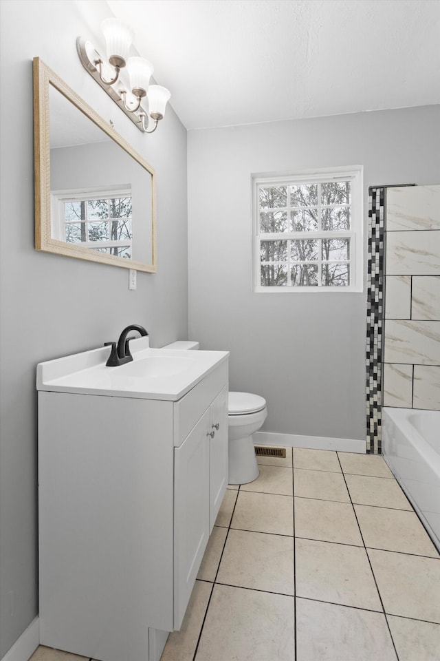 bathroom with tile patterned floors, vanity, and toilet