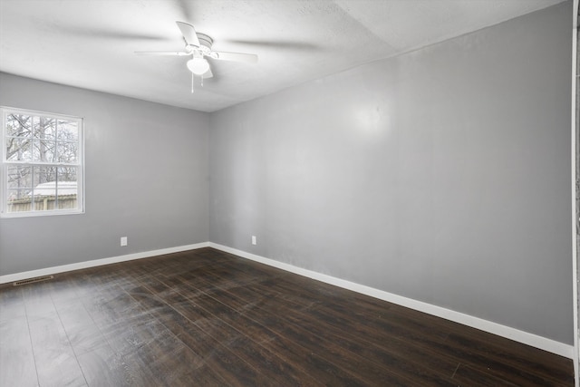 spare room with ceiling fan, dark hardwood / wood-style flooring, and a textured ceiling