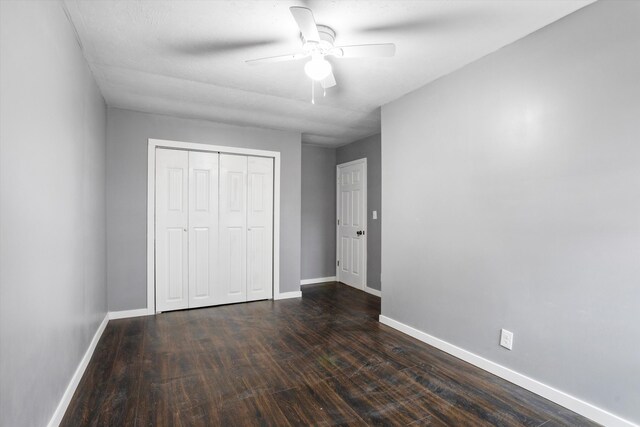 unfurnished bedroom featuring a closet, ceiling fan, and dark hardwood / wood-style floors