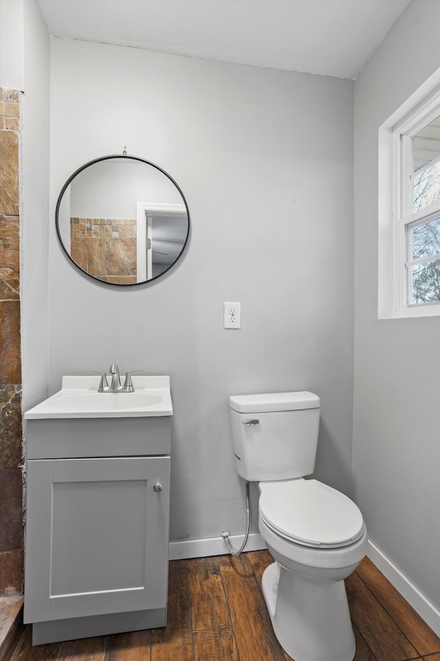 bathroom with hardwood / wood-style flooring, vanity, and toilet