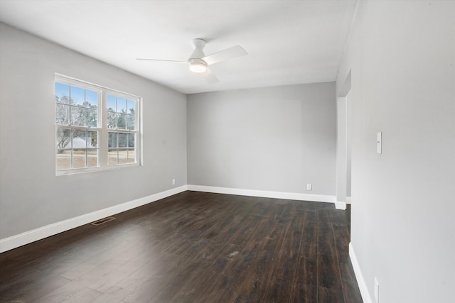 empty room featuring ceiling fan and dark hardwood / wood-style flooring