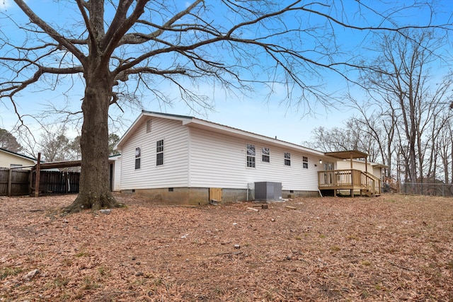 rear view of property with central AC and a wooden deck