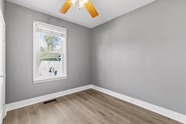 spare room featuring ceiling fan and hardwood / wood-style floors