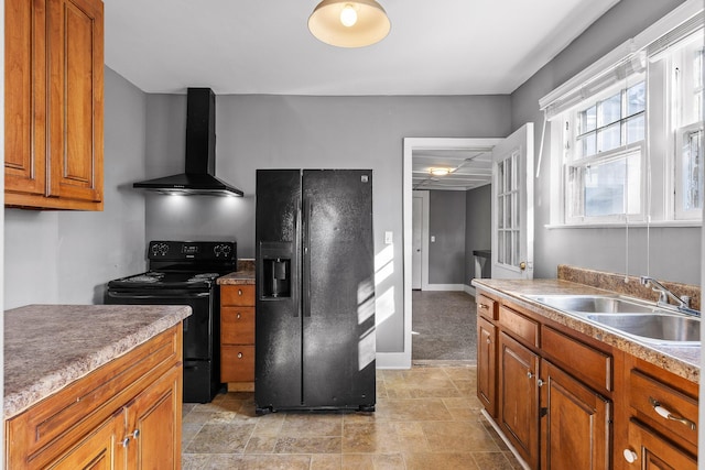 kitchen with wall chimney range hood, sink, light colored carpet, and black appliances