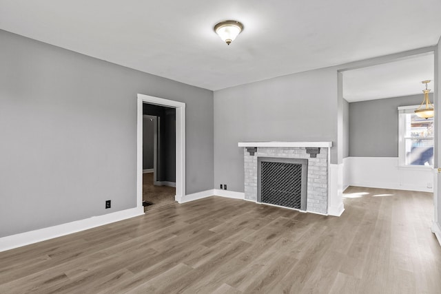 unfurnished living room with hardwood / wood-style floors and a fireplace